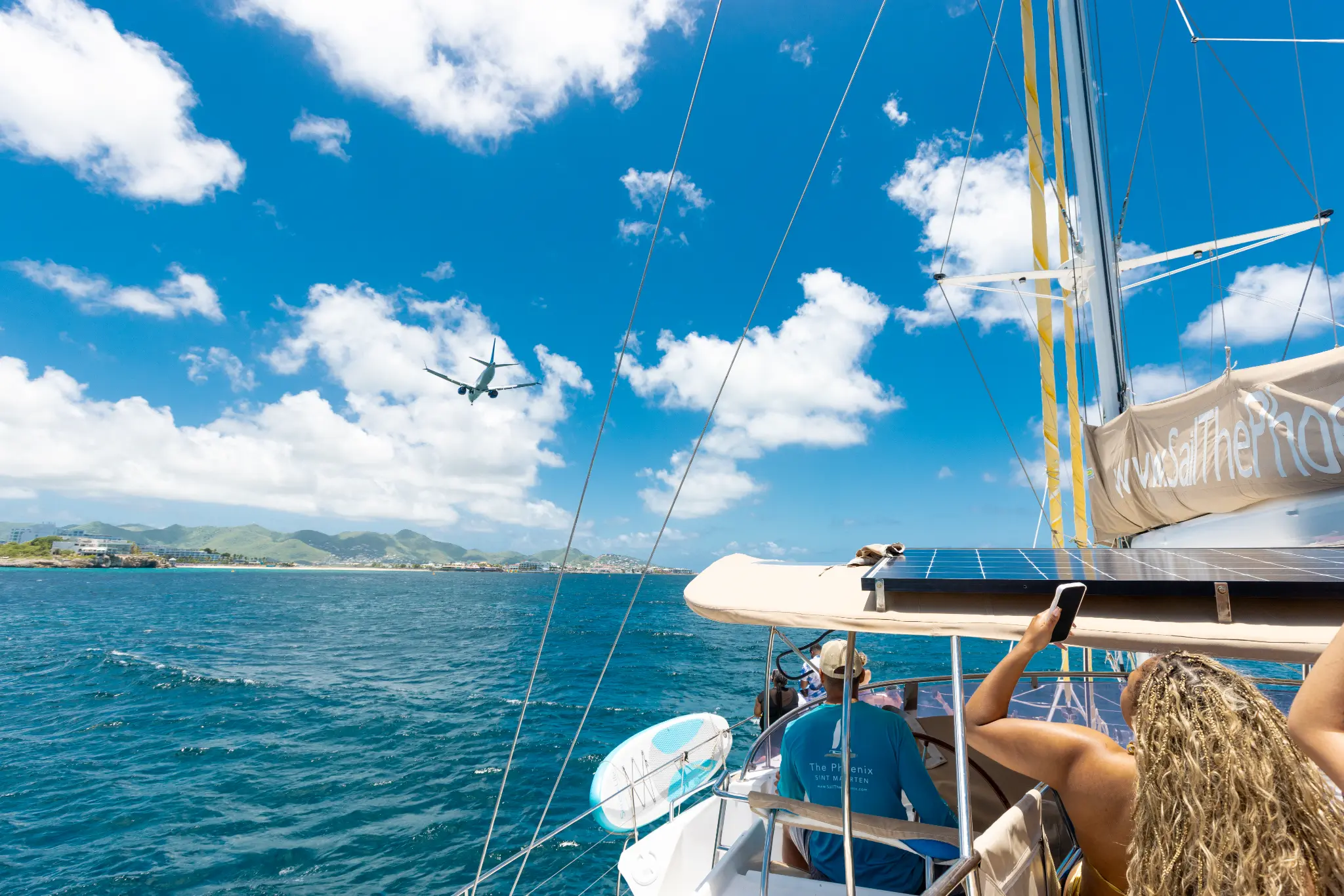 The Phoenix catamaran with plane landing overhead, St. Maarten