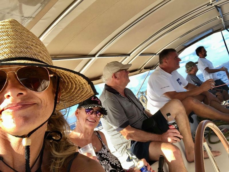 Guest taking selfie with Captain at the helm on the flybridge of Sail The Phoenix