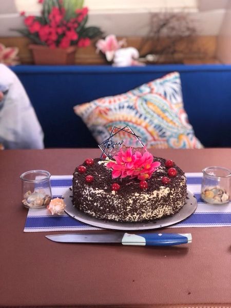 Celebration cake with white frosting on a table aboard Sail The Phoenix