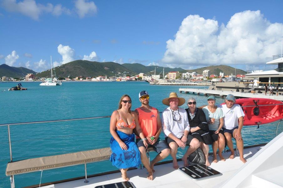 Guest reclining on the sun deck cushions of Sail The Phoenix gazing at the Caribbean